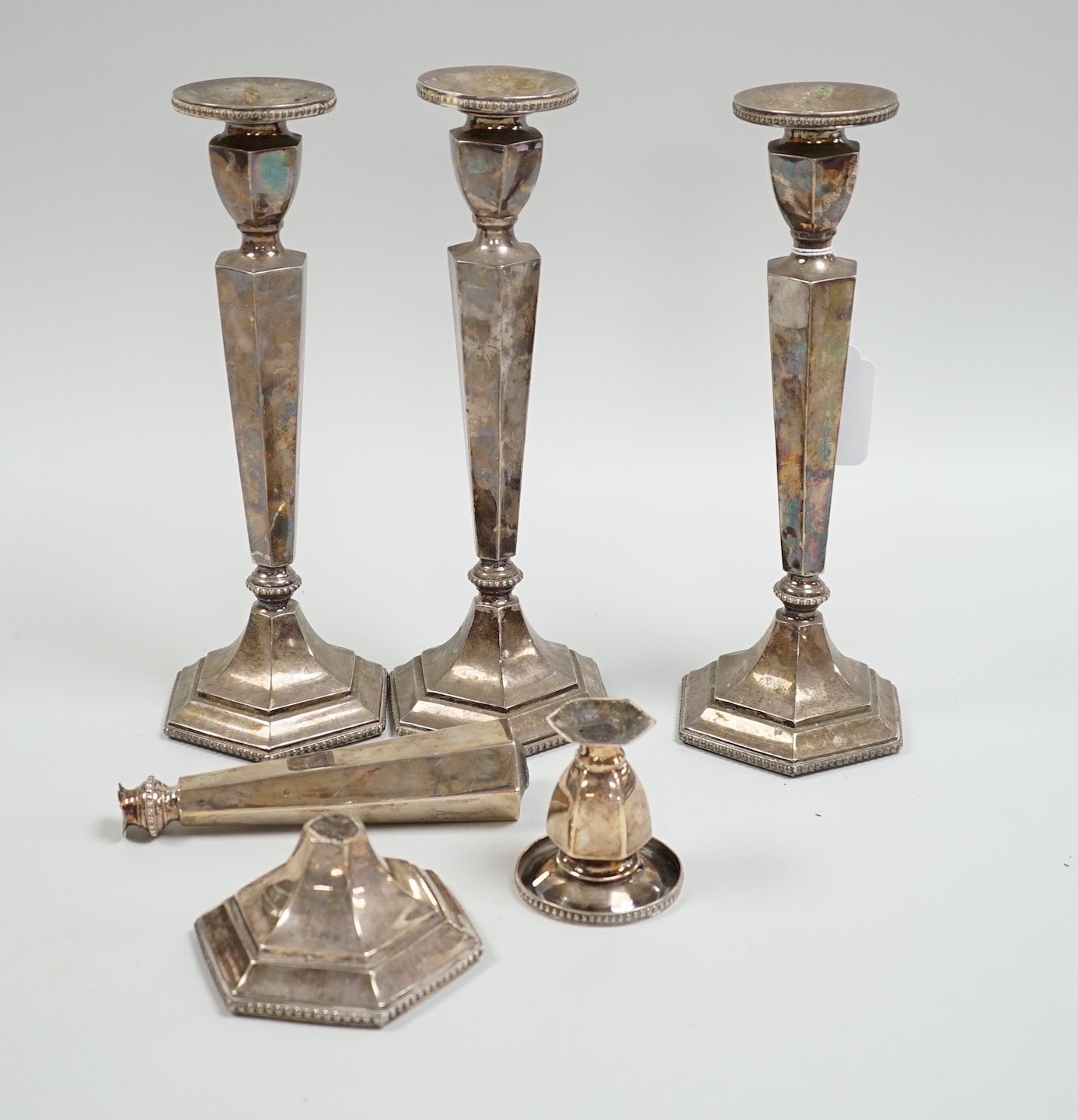 A set of four Chinese Export sterling candlesticks, Tien Tsin, Yeching, one a.f., 26.4cm, weighted.